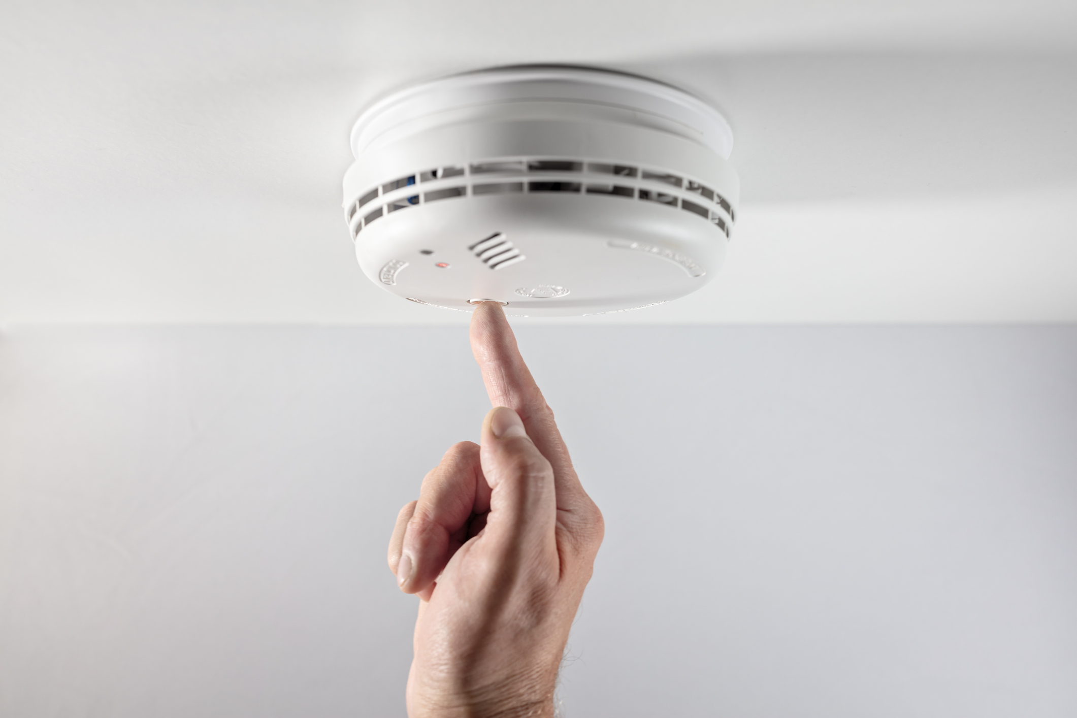 Inspector checking smoke alarm