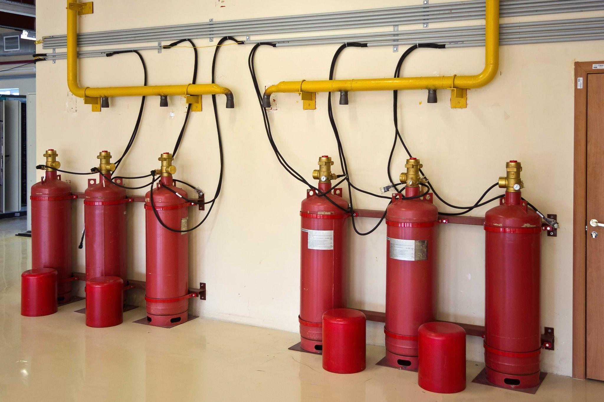 CO2 fire extinguisher tanks mounted on a wall